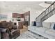 Open-concept living space featuring hardwood floors, a cozy seating area, and a stylish kitchen at 8714 Palm Ranches Pl, Tampa, FL 33614