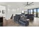 An upstairs living room features hardwood floors, a dark couch with pillows, and sliding glass doors at 8714 Palm Ranches Pl, Tampa, FL 33614