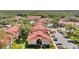 A high angle shot of condominium buildings and a swimming pool bordered by mature trees, greenery, and a parking lot at 9481 Highland Oak Dr # 806, Tampa, FL 33647