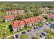 Aerial view of condo community with red tile roofs, community pool and green landscaping at 9481 Highland Oak Dr # 806, Tampa, FL 33647