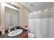Cozy bathroom features a single sink vanity, a large mirror, and a shower with a white curtain at 9481 Highland Oak Dr # 806, Tampa, FL 33647