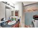 Bathroom with vanity and sink, alongside a laundry area with machines at 9481 Highland Oak Dr # 806, Tampa, FL 33647