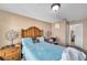 Bedroom with blue bedding, neutral walls and carpet, with a view of the en-suite bathroom at 9481 Highland Oak Dr # 806, Tampa, FL 33647