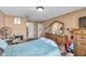 Bedroom with neutral walls and carpeting, featuring a bed and a view into the hallway at 9481 Highland Oak Dr # 806, Tampa, FL 33647