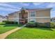 Inviting tan condo building featuring well-maintained landscaping and a welcoming walkway at 9481 Highland Oak Dr # 806, Tampa, FL 33647