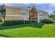 Comfortable condo complex with manicured lawn, mature shrubs, and inviting facade at 9481 Highland Oak Dr # 806, Tampa, FL 33647