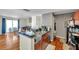 The open kitchen features stainless steel sink, dark counter tops, and diamond wallpaper accenting the room at 9481 Highland Oak Dr # 806, Tampa, FL 33647