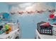 Laundry room with two washing machines, shelving, and playful wall decor at 9481 Highland Oak Dr # 806, Tampa, FL 33647