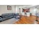 Bright and airy living room features wood floors and an open layout leading to the kitchen at 9481 Highland Oak Dr # 806, Tampa, FL 33647