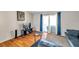 Living room with sliding glass doors to the lanai area, wood floors, and a comfortable seating arrangement at 9481 Highland Oak Dr # 806, Tampa, FL 33647