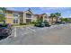 Condo complex with designated visitor parking; tan buildings with red roofs in the background at 9481 Highland Oak Dr # 806, Tampa, FL 33647