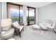 Cozy sitting area with chairs and a table offering a view of the balcony and beyond at 1 Key Capri # 606W, Treasure Island, FL 33706
