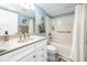 Charming bathroom featuring a pristine white vanity, tiled shower, and ample lighting at 1 Key Capri # 606W, Treasure Island, FL 33706