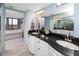 Bathroom boasts double sinks with dark granite countertops and a sleek design at 1 Key Capri # 606W, Treasure Island, FL 33706