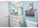 Well-lit bathroom with a classic vanity, light blue walls, and tasteful decor at 1 Key Capri # 606W, Treasure Island, FL 33706