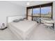 Inviting bedroom with a modern desk area, plush carpet, and picturesque outdoor views at 1 Key Capri # 606W, Treasure Island, FL 33706