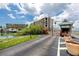 Beautiful waterfront condo building with secured entrance, lush landscaping, and plenty of parking at 1 Key Capri # 606W, Treasure Island, FL 33706