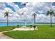 Lush community area with BBQ grills, picnic tables, putting green, and waterfront views at 1 Key Capri # 606W, Treasure Island, FL 33706
