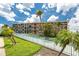 Beautiful multi-story condo building with palm trees and blue sky view at 1 Key Capri # 606W, Treasure Island, FL 33706