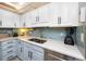 Bright kitchen with quartz countertops, stainless steel appliances, and ample cabinet space at 1 Key Capri # 606W, Treasure Island, FL 33706