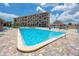 Community swimming pool and sunbathing deck with lounge chairs, and shade cabana for relaxing by the pool at 1 Key Capri # 606W, Treasure Island, FL 33706
