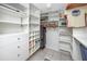 Walk-in closet with custom shelving, drawers, and ample storage space at 1 Key Capri # 606W, Treasure Island, FL 33706