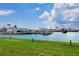 Scenic waterfront view featuring a marina with boat docks and a vibrant cityscape in the distance at 1 Key Capri # 606W, Treasure Island, FL 33706