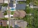 Aerial view of residential homes featuring swimming pools, lush landscaping, and driveways at 10021 Brompton Dr, Tampa, FL 33626