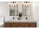 Bright bathroom with double vanity, modern faucets, framed mirrors, accent lighting, and shiplap wall at 10021 Brompton Dr, Tampa, FL 33626