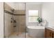 Modern bathroom features a glass enclosed shower, soaking tub, and accent tile detail at 10021 Brompton Dr, Tampa, FL 33626