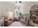 Cozy Bedroom with a crib, comfortable chair, neutral decor, and natural light at 10021 Brompton Dr, Tampa, FL 33626