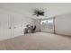 Bright bedroom featuring neutral carpet, ceiling fan, and natural light from the double window at 10021 Brompton Dr, Tampa, FL 33626