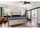 Main bedroom with stylish decor, sliding glass doors to bathroom, and modern ceiling fan at 10021 Brompton Dr, Tampa, FL 33626