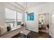 Bright dining area with a window seat, modern chandelier, and a view into the main dining area at 10021 Brompton Dr, Tampa, FL 33626