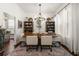 Elegant dining room featuring stylish chandelier, shelving, hardwood floors, and lots of light at 10021 Brompton Dr, Tampa, FL 33626