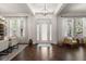 Bright foyer featuring hardwood floors, high ceilings, and a stylish chandelier at 10021 Brompton Dr, Tampa, FL 33626
