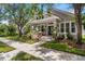 Charming home with a well-maintained lawn and landscaping with mature shade trees and a welcoming front porch at 10021 Brompton Dr, Tampa, FL 33626