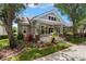 Charming home showcasing lush landscaping, and a welcoming covered porch area at 10021 Brompton Dr, Tampa, FL 33626