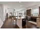 Open concept kitchen with island, stainless steel appliances, dark wood cabinets, and seating for three at 10021 Brompton Dr, Tampa, FL 33626