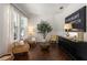 Bright living room featuring hardwood floors, neutral decor, large windows, and stylish furnishings at 10021 Brompton Dr, Tampa, FL 33626