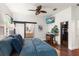 Spacious main bedroom with ensuite bathroom, walk in closet, ceiling fan, and flatscreen TV at 10021 Brompton Dr, Tampa, FL 33626