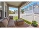 Covered porch with comfortable seating area and view of fenced backyard at 10021 Brompton Dr, Tampa, FL 33626