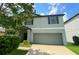 Charming two-story home with a well-manicured lawn and a two-car garage at 10108 Rosemary Leaf Ln, Riverview, FL 33578
