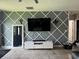 Modern living room with custom wall design and entertainment center, plus a cozy feel at 10108 Rosemary Leaf Ln, Riverview, FL 33578