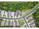 This aerial view shows homes situated on well-maintained streets, complemented by lush green spaces and mature trees at 11144 Paradise Point Way, New Port Richey, FL 34654