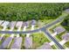 An aerial view of a house in a neighborhood, surrounded by green trees at 11144 Paradise Point Way, New Port Richey, FL 34654