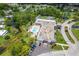 An aerial view of a community clubhouse and pool surrounded by lush greenery and residences at 11144 Paradise Point Way, New Port Richey, FL 34654