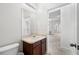 Bathroom featuring a vanity with sink, adjacent to a toilet and open doorway at 11144 Paradise Point Way, New Port Richey, FL 34654