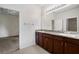 Bathroom featuring dual sinks with a stone countertop and dark wood cabinets at 11144 Paradise Point Way, New Port Richey, FL 34654