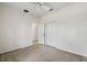Carpeted bedroom with neutral walls, featuring a large closet and doorway at 11144 Paradise Point Way, New Port Richey, FL 34654